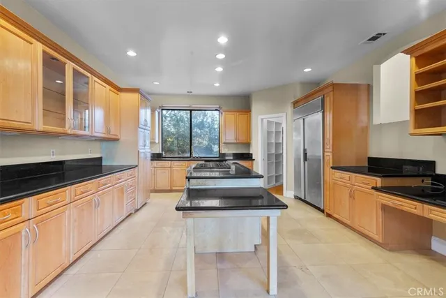 a kitchen with stainless steel appliances granite countertop a stove and a sink