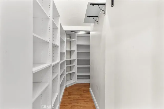 a kitchen with granite countertop white cabinets and black stainless steel appliances