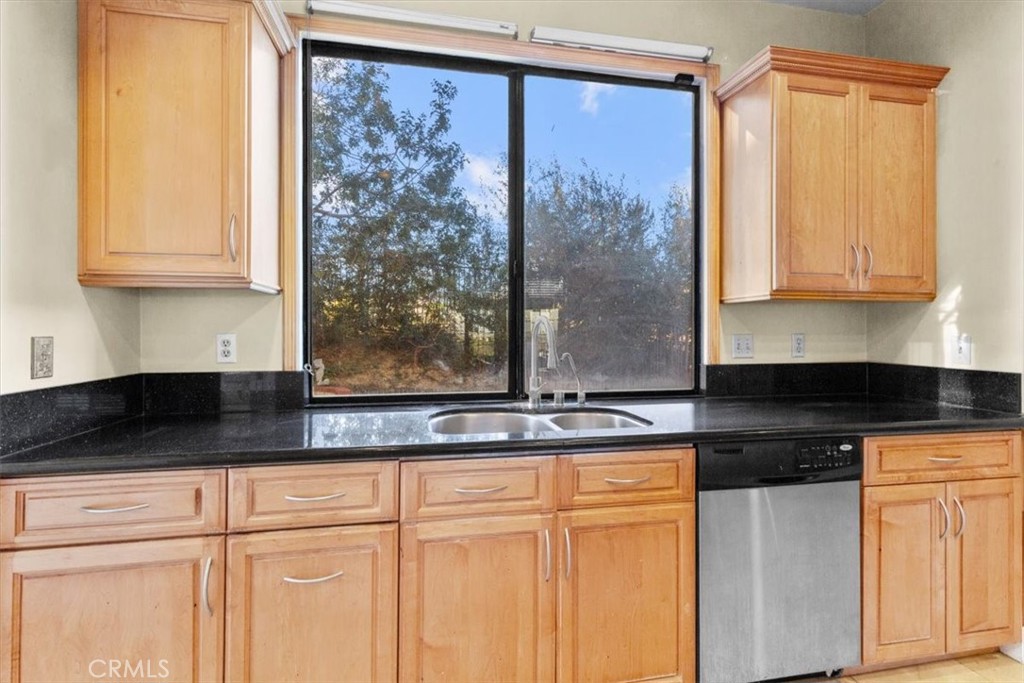 1500 Kashlan Road La Habra Heights, CA 90631 - Photo 37 of 62 a kitchen with granite countertop white cabinets and black stainless steel appliances