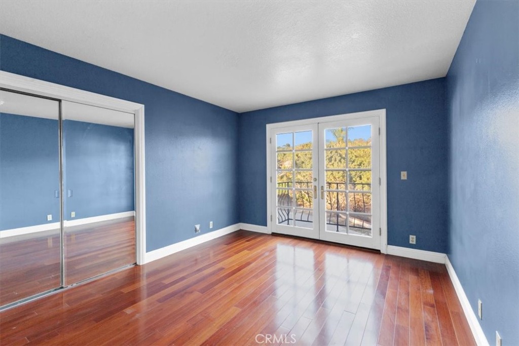 1500 Kashlan Road La Habra Heights, CA 90631 - Photo 40 of 62 an empty room with wooden floor and sliding door