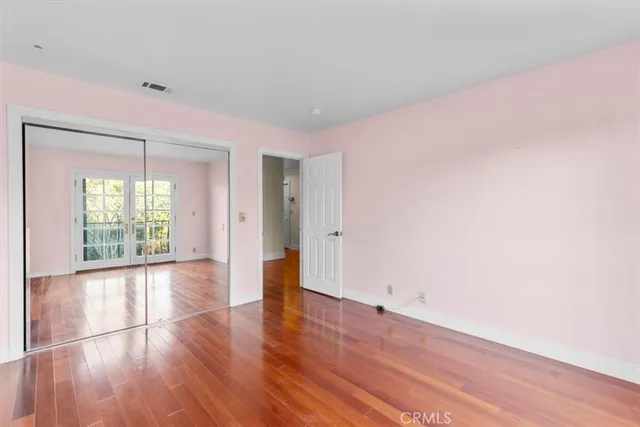 a view of a room with wooden floor and city view