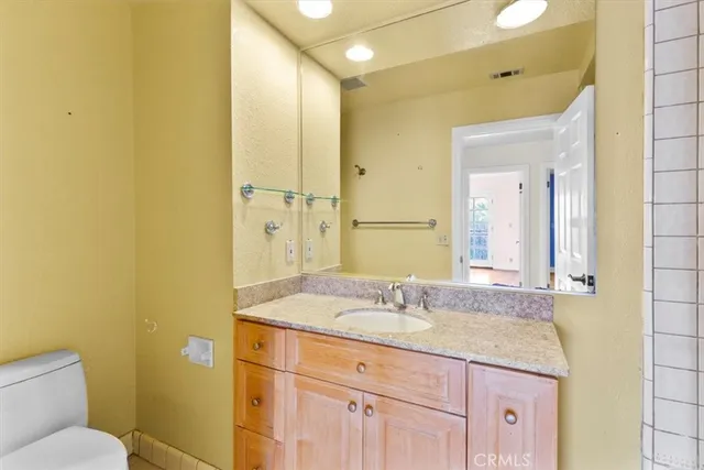 a living room with furniture large window and wooden floor