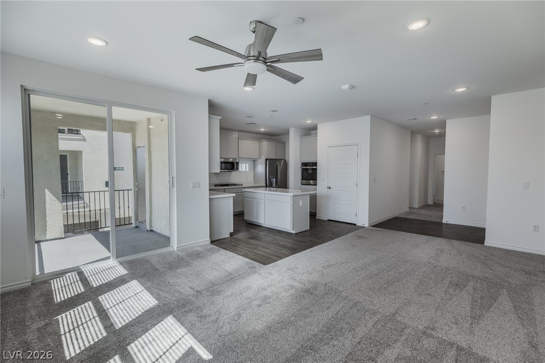 2555 Hampton Road, Unit 8206 Henderson, NV 89052 - Photo 5 of 35 This bright, open-concept living space integrates a modern kitchen and offers access to a private balcony.