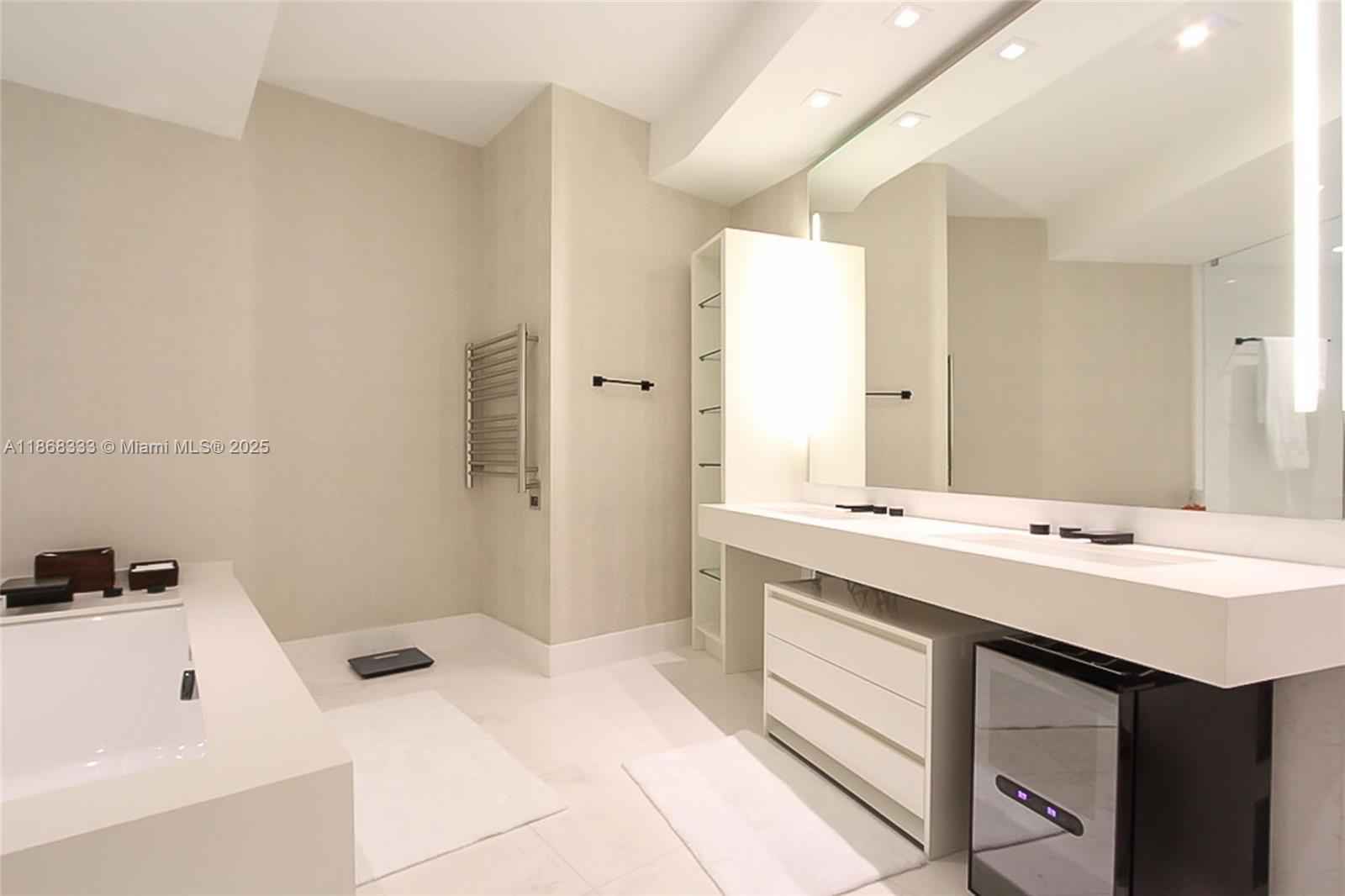 18555 Collins Avenue, Unit 4605 Sunny Isles Beach, FL 33160 - Photo 20 of 40 a spacious bathroom with a sink a mirror and a bathtub
