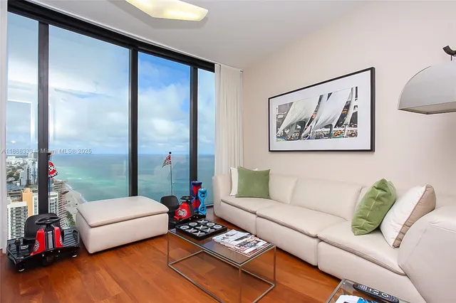 a bedroom with furniture and a large window