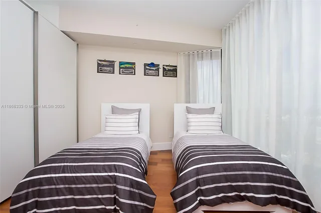 a bathroom with a granite countertop sink a toilet a mirror and shower