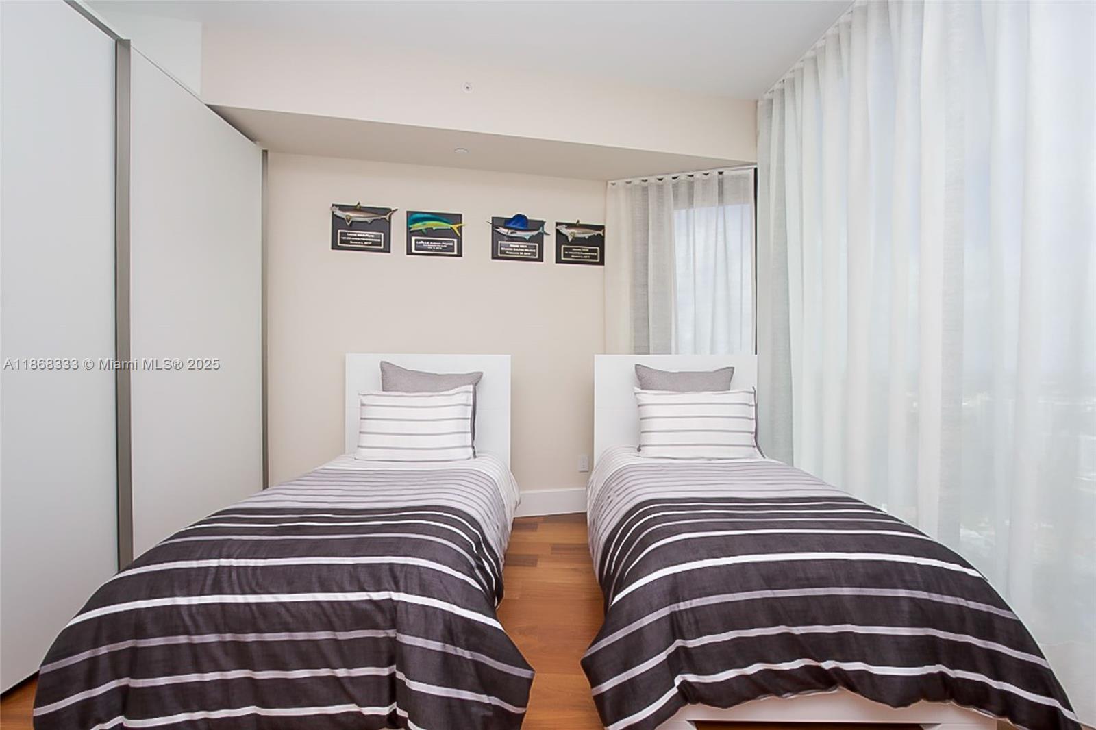 18555 Collins Avenue, Unit 4605 Sunny Isles Beach, FL 33160 - Photo 36 of 40 a bedroom with a bed and a window