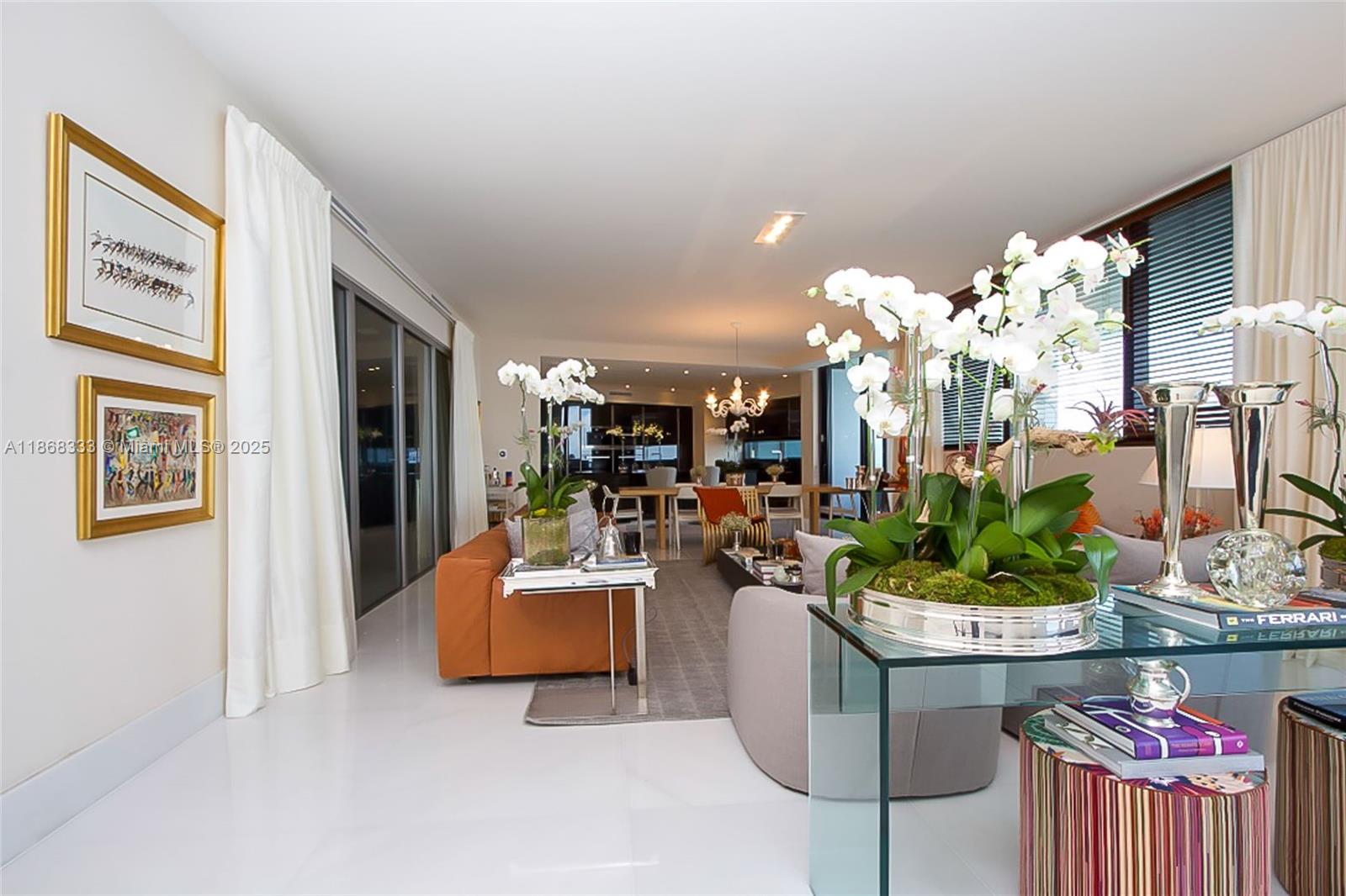 18555 Collins Avenue, Unit 4605 Sunny Isles Beach, FL 33160 - Photo 7 of 40 a living room with furniture and a chandelier