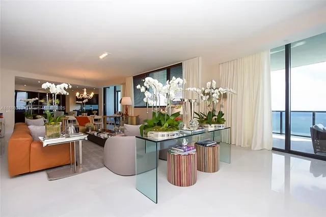 a living room with furniture a fireplace and a potted plant