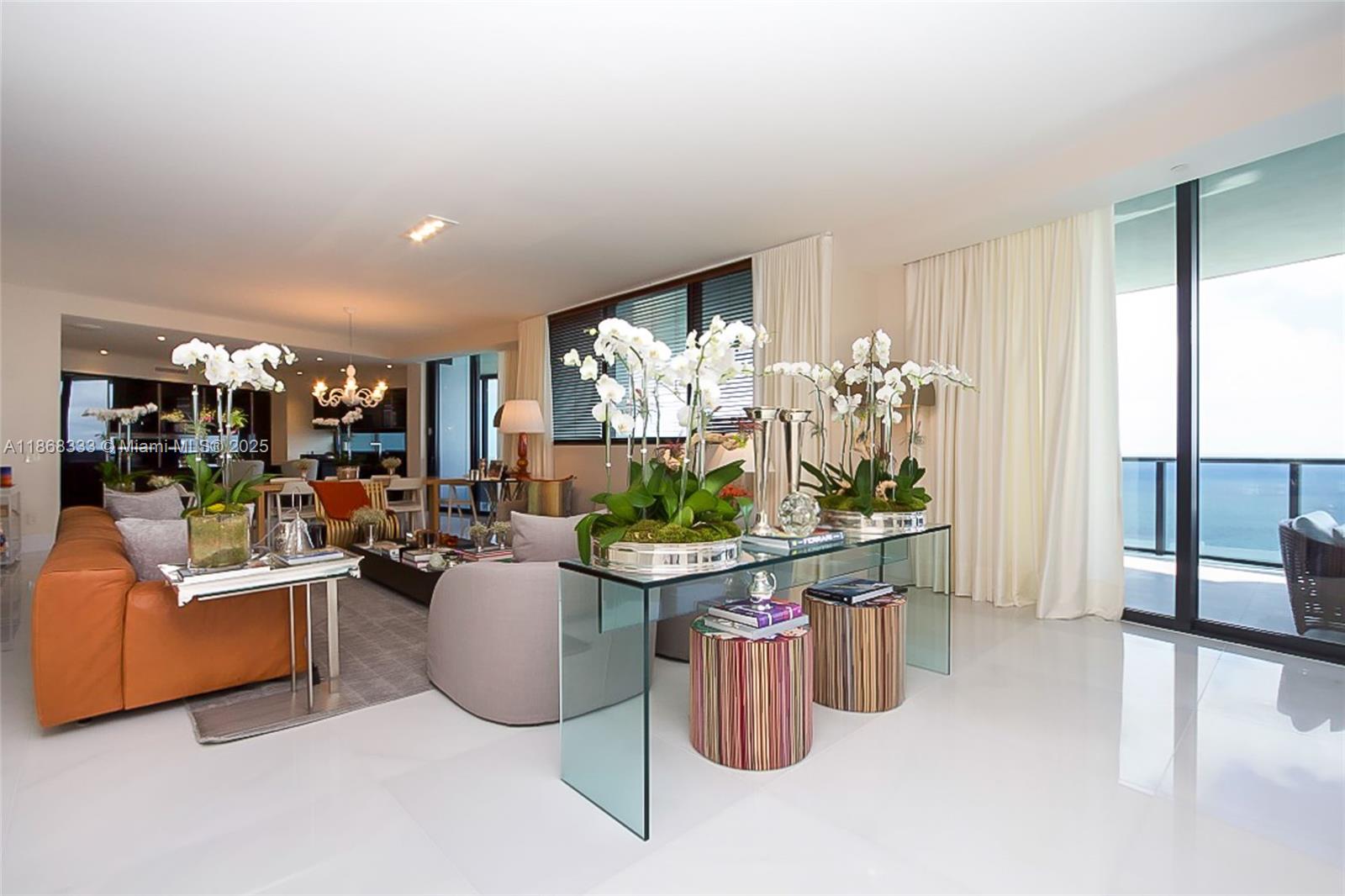 18555 Collins Avenue, Unit 4605 Sunny Isles Beach, FL 33160 - Photo 8 of 40 a living room with furniture a fireplace and a potted plant