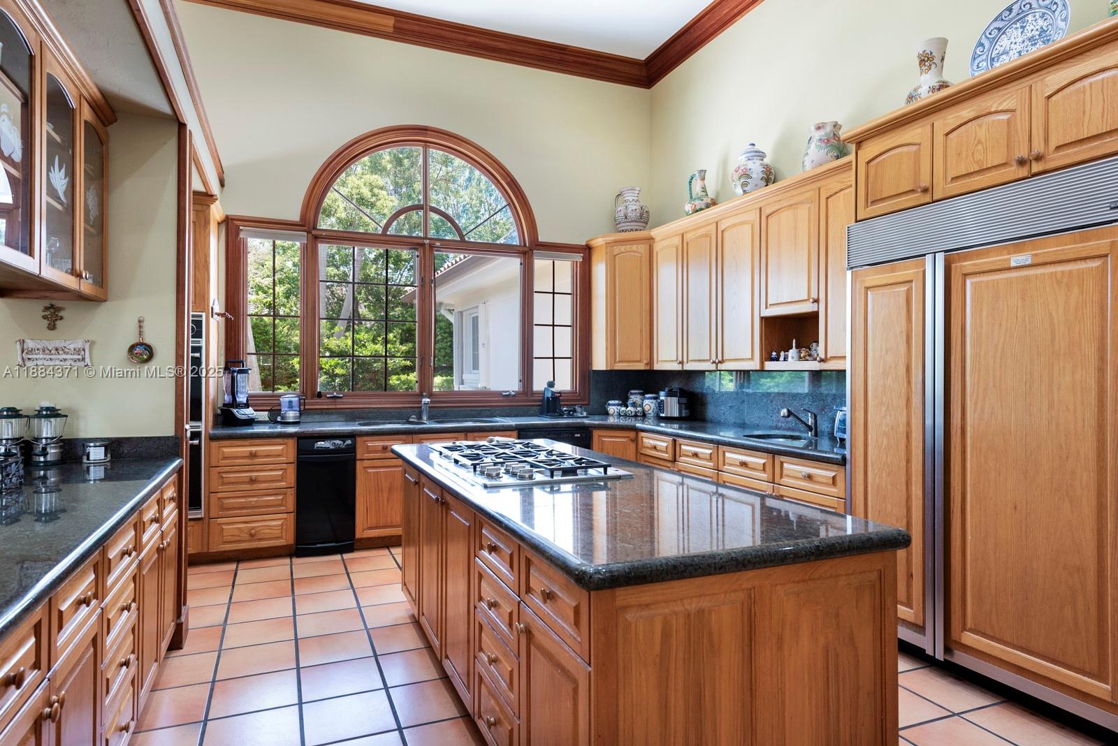 9360 Southwest 66th Street Miami, FL 33173 - Photo 17 of 64 a kitchen with stainless steel appliances granite countertop a stove a sink dishwasher and cabinets with wooden floor