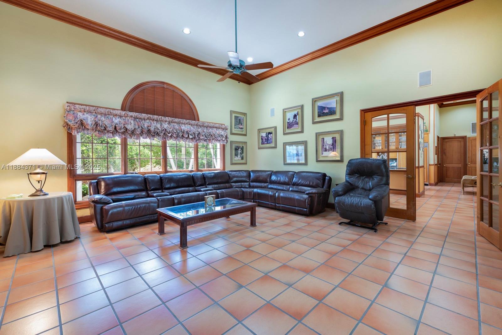 9360 Southwest 66th Street Miami, FL 33173 - Photo 20 of 64 a living room with furniture a chandelier and a large window