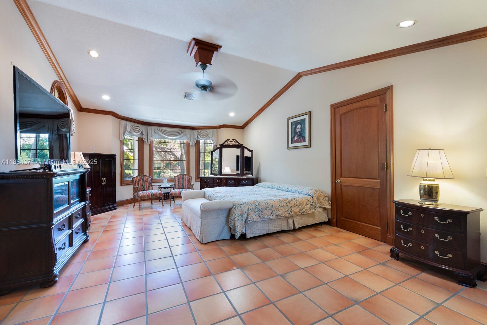 9360 Southwest 66th Street Miami, FL 33173 - Photo 24 of 64 a spacious bedroom with a large bed and a dresser