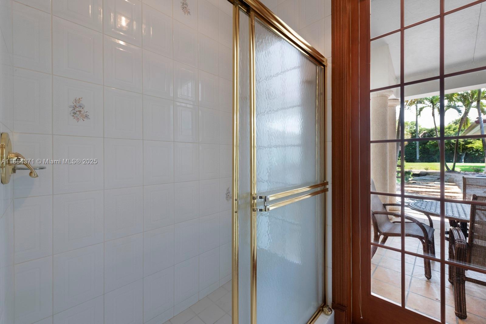 9360 Southwest 66th Street Miami, FL 33173 - Photo 27 of 64 a bathroom with a glass shower door