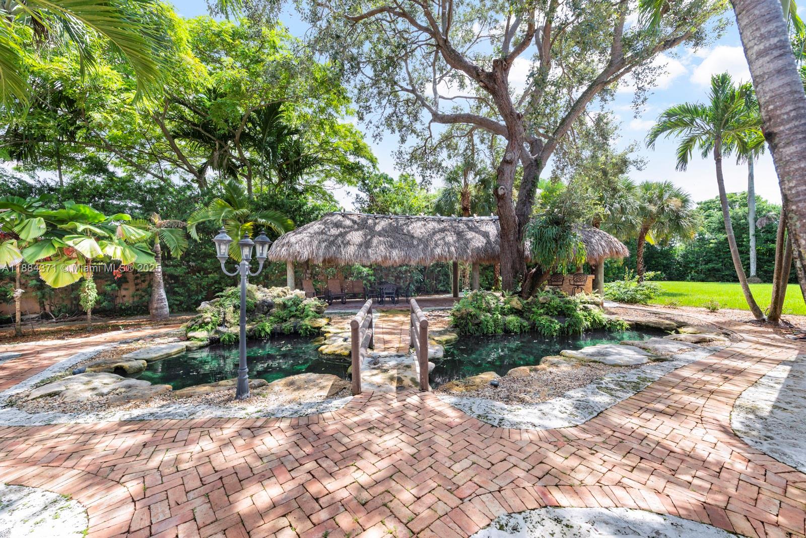 9360 Southwest 66th Street Miami, FL 33173 - Photo 30 of 64 a view of a backyard with a garden and swimming pool