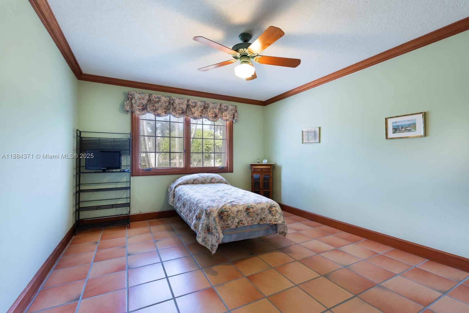 9360 Southwest 66th Street Miami, FL 33173 - Photo 40 of 64 a bedroom with a bed and a window