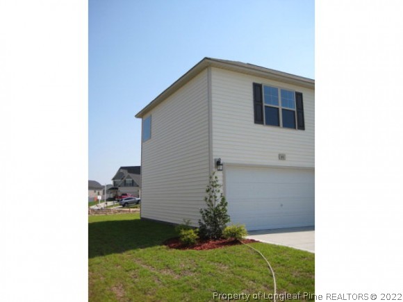 83 Loyalist Road Cameron, NC 28326 - Photo 5 of 6 a house view with a backyard space