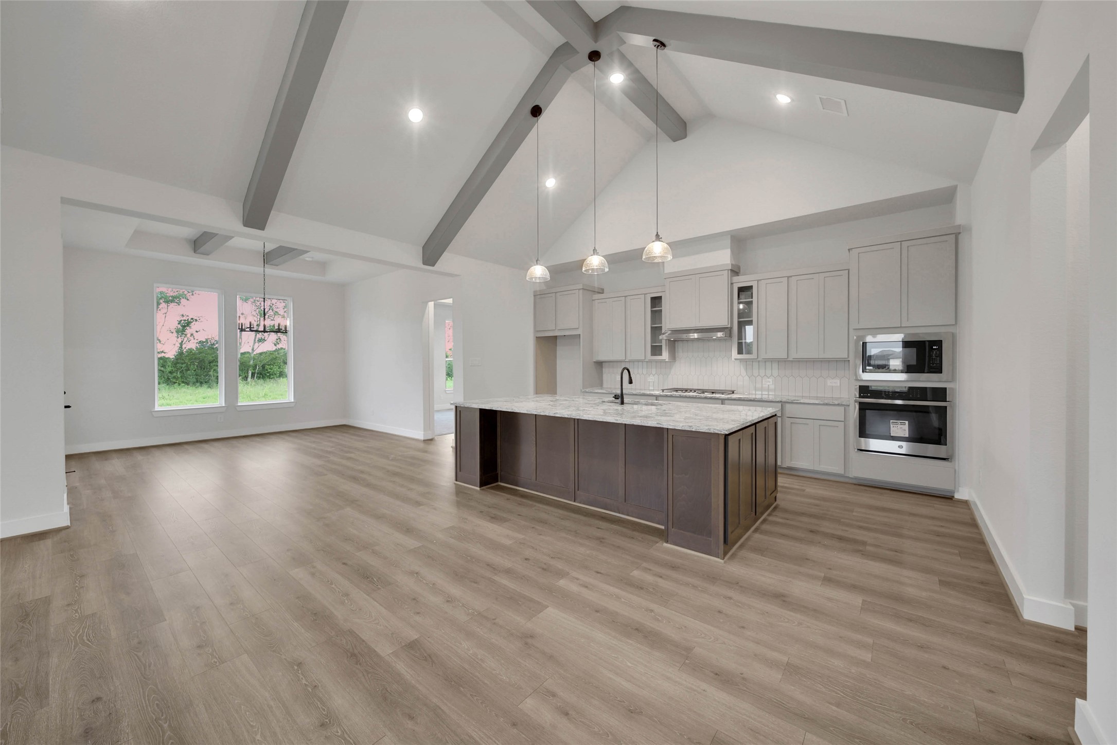 4610 Magnolia Bend Drive Rosharon, TX 77583 - Photo 9 of 48 a large kitchen with stainless steel appliances kitchen island wooden floors and view living room