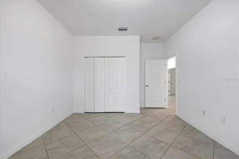 a empty room with sliding glass door and mountain view