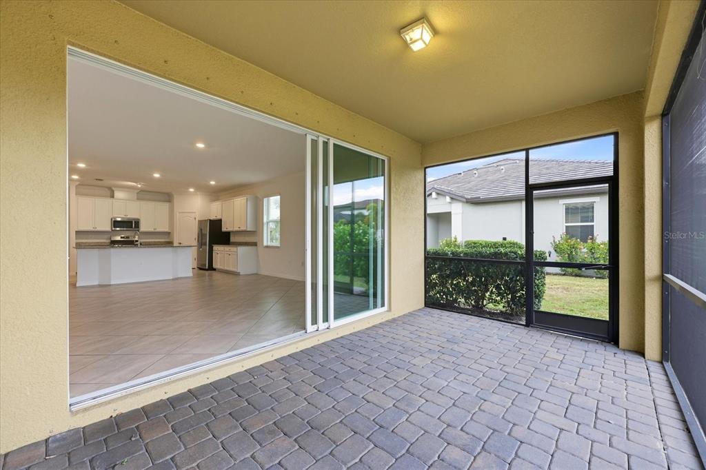 2607 Avolet Court Lakewood Ranch, FL 34211 - Photo 26 of 56 a empty room with sliding glass door and mountain view