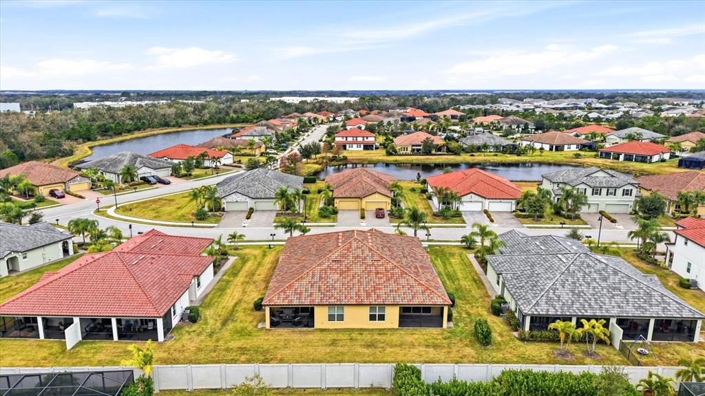 2607 Avolet Court Lakewood Ranch, FL 34211 - Photo 34 of 56 an aerial view of residential houses with outdoor space and swimming pool