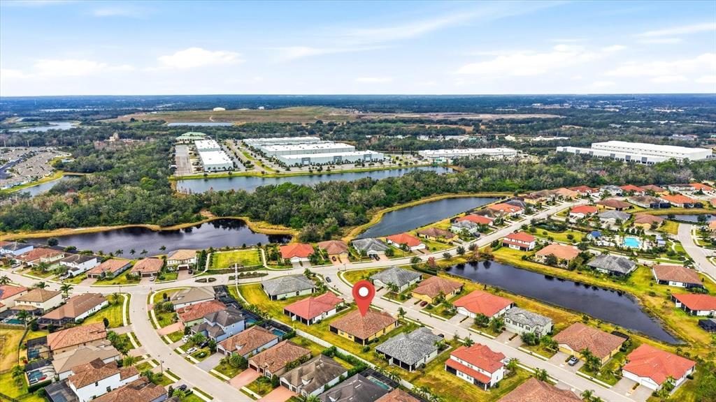 2607 Avolet Court Lakewood Ranch, FL 34211 - Photo 35 of 56 an aerial view of residential building and lake view