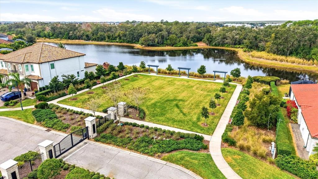 2607 Avolet Court Lakewood Ranch, FL 34211 - Photo 54 of 56 a view of a swimming pool with a patio and a garden