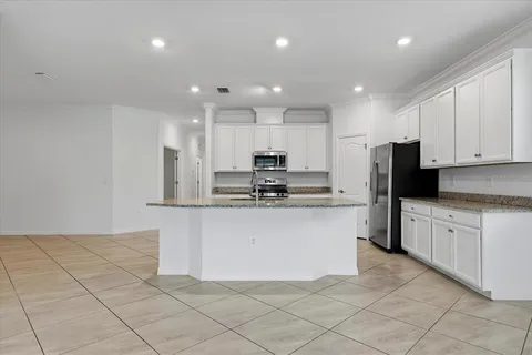 a kitchen with stainless steel appliances granite countertop a refrigerator and a sink