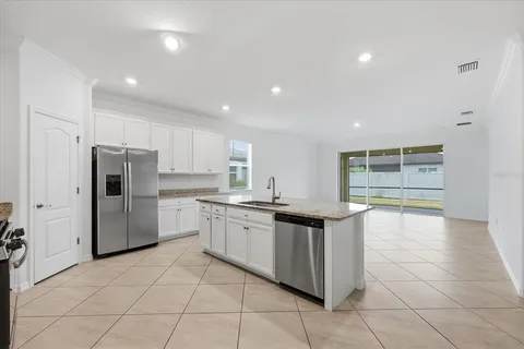 a view of kitchen refrigerator and window