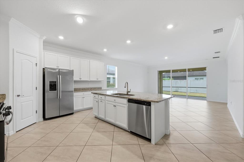 2607 Avolet Court Lakewood Ranch, FL 34211 - Photo 9 of 56 a kitchen with stainless steel appliances granite countertop a refrigerator and a sink