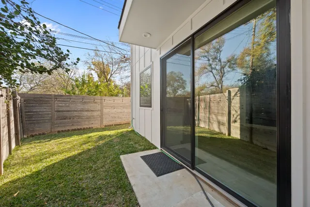 a view of a porch with wooden floor and a yard