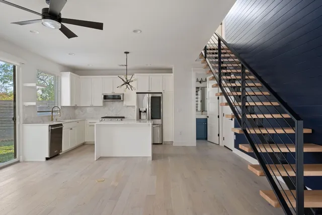 a view of a kitchen with cabinets and wooden floor