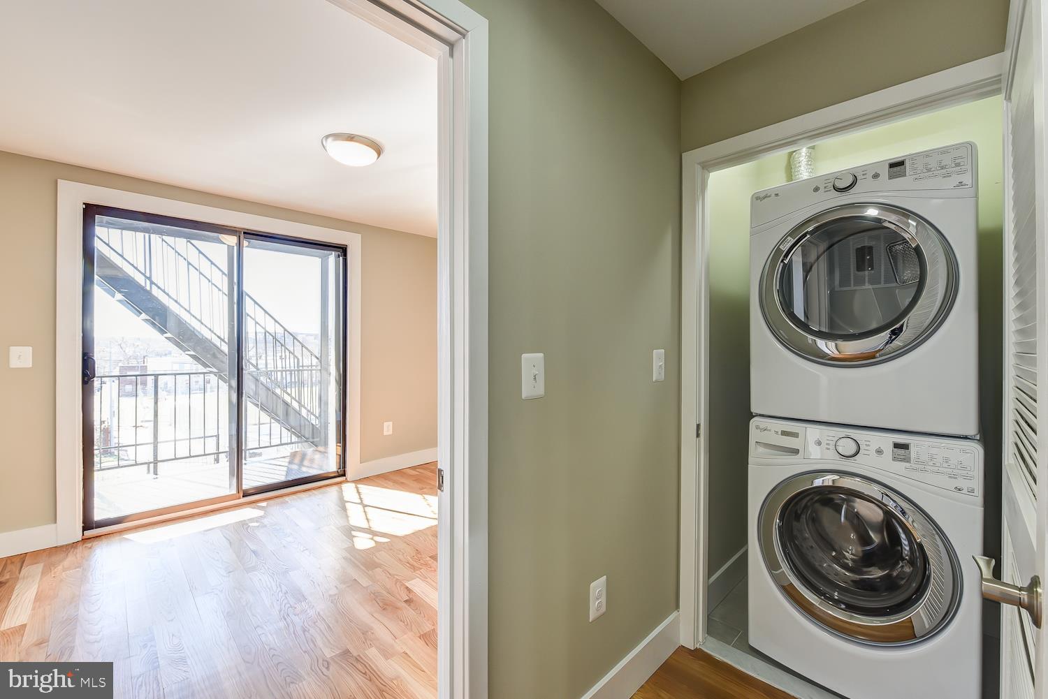 2031 Benning Road Northeast, Unit B Washington, DC 20002 - Photo 12 of 22 a view of a hallway with washer and dryer to ceiling window