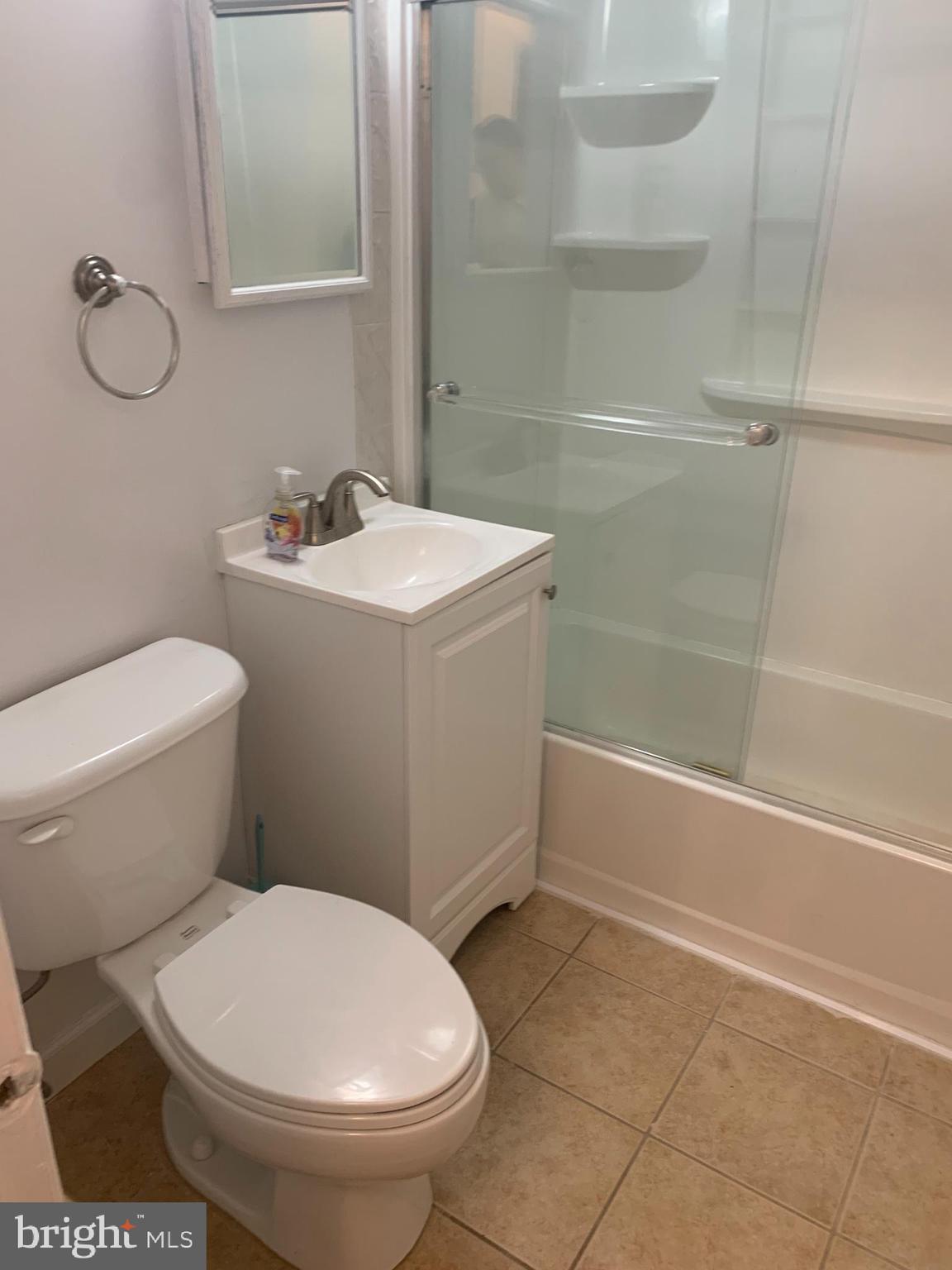 11410 Cherry Hill Road, Unit MB104 Beltsville, MD 20705 - Photo 3 of 8 a white toilet sitting next to a bath tub