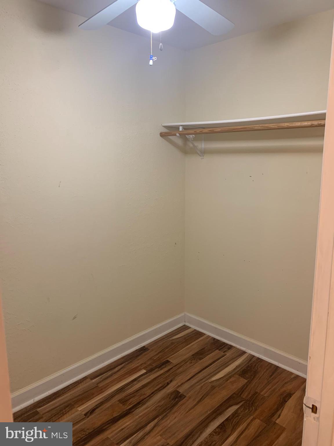 11410 Cherry Hill Road, Unit MB104 Beltsville, MD 20705 - Photo 5 of 8 a view of a room with wooden floor and fan