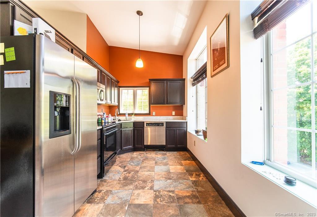 a large white kitchen with a large window