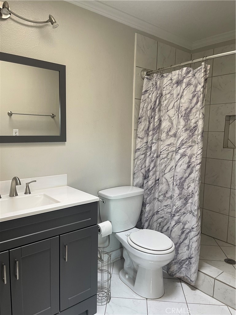 26380 Erwin Court Hemet, CA 92544 - Photo 6 of 12 a bathroom with a toilet a sink and a mirror
