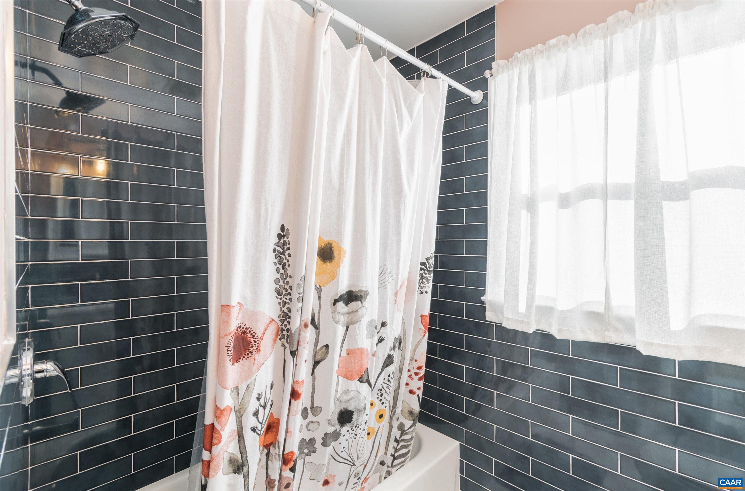 707 Rockcreek Road Charlottesville, VA 22903 - Photo 12 of 26 a bathroom with a shower curtain and a window