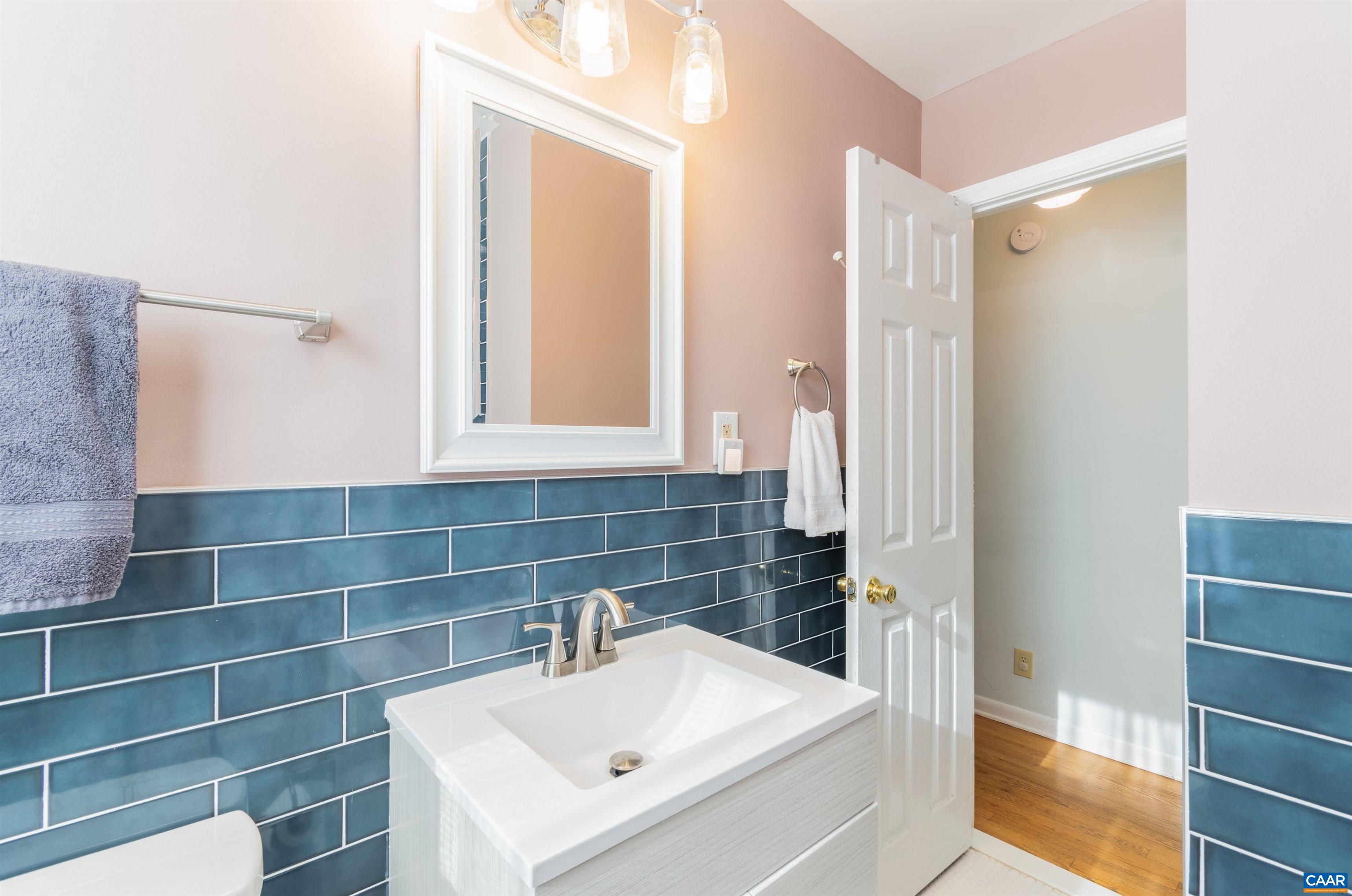 707 Rockcreek Road Charlottesville, VA 22903 - Photo 13 of 26 a bathroom with a sink and a mirror