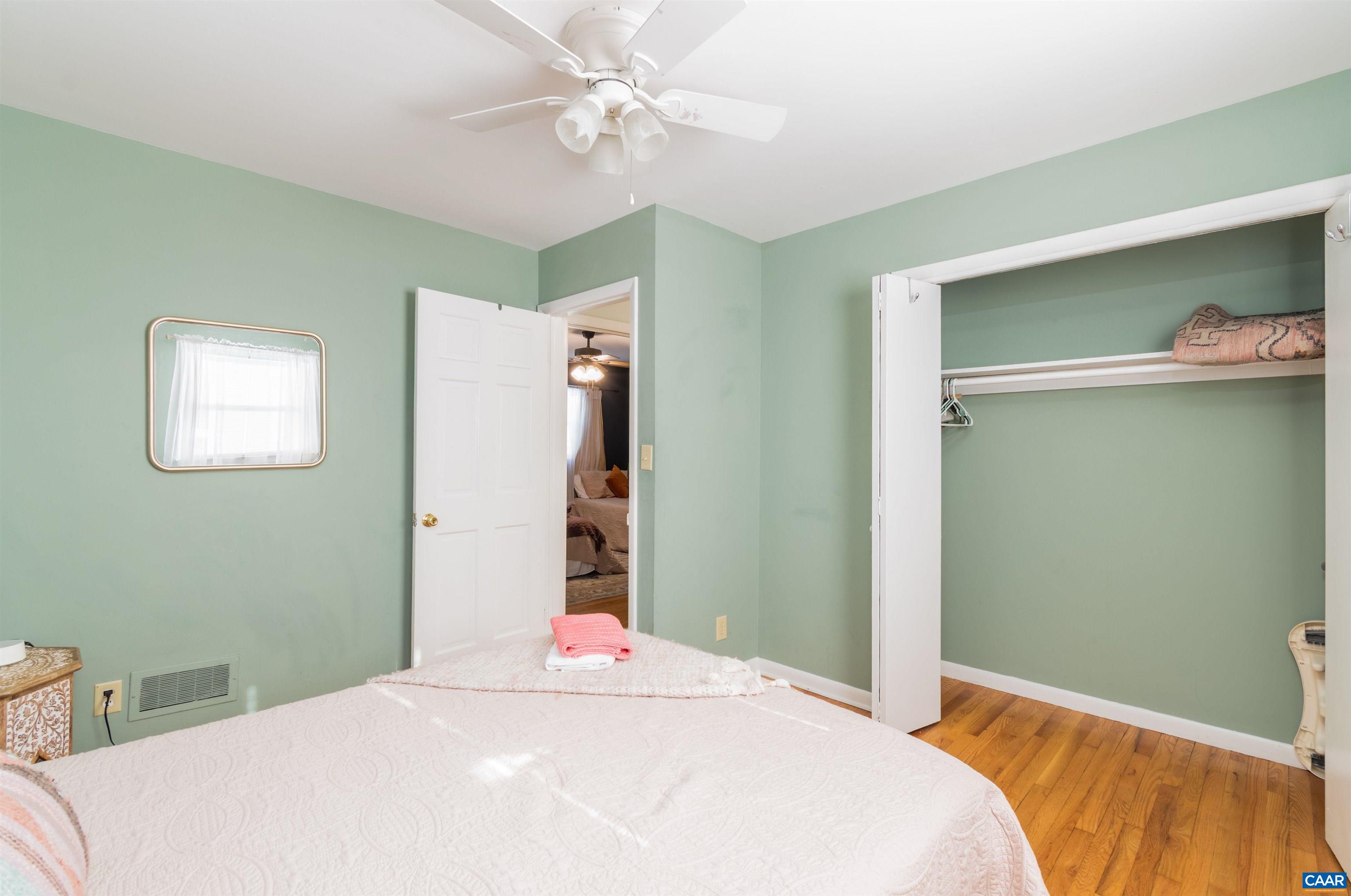 707 Rockcreek Road Charlottesville, VA 22903 - Photo 15 of 26 a bedroom with a bed and a chandelier