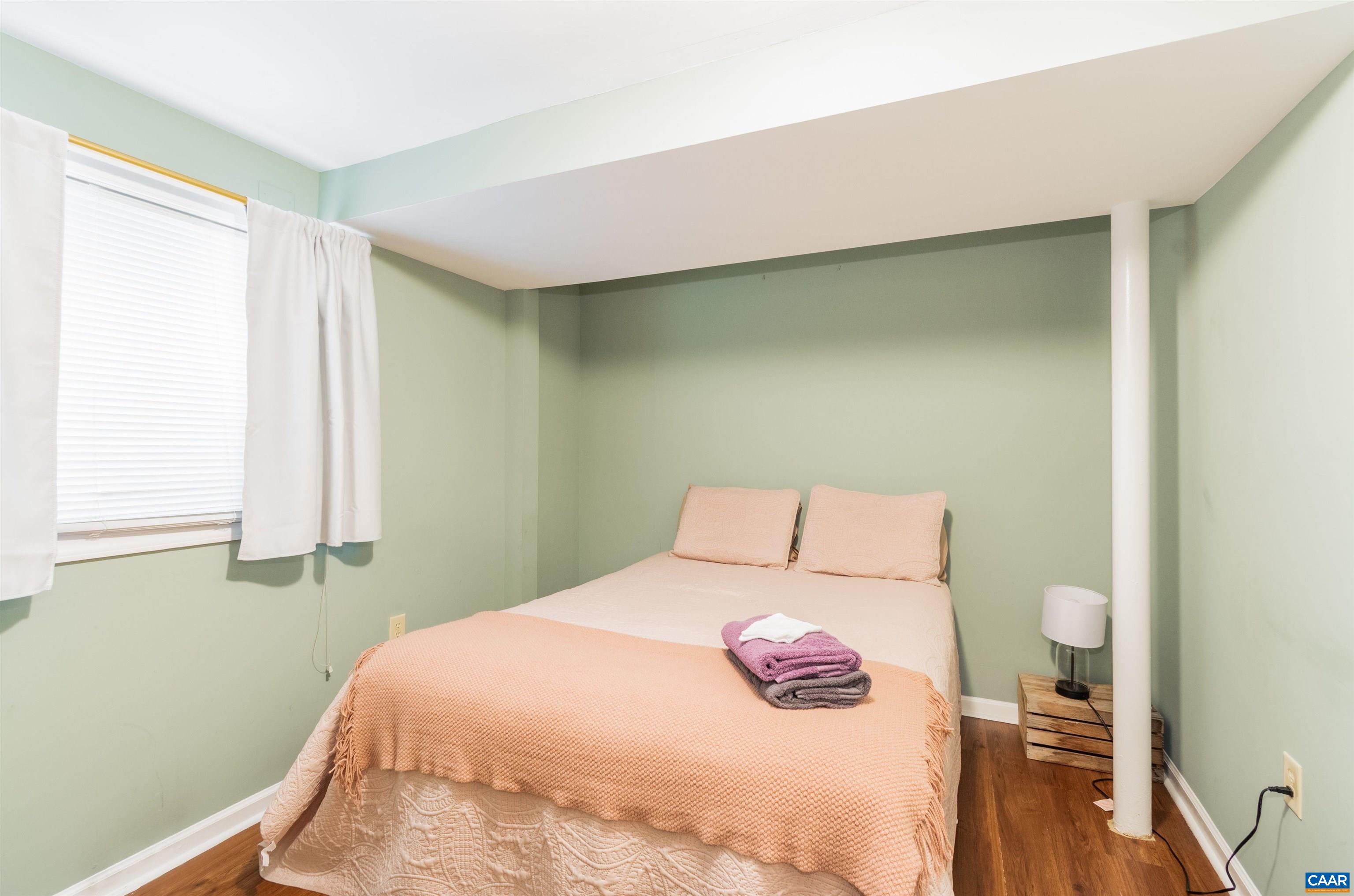 707 Rockcreek Road Charlottesville, VA 22903 - Photo 18 of 26 a bedroom with a bed and a window