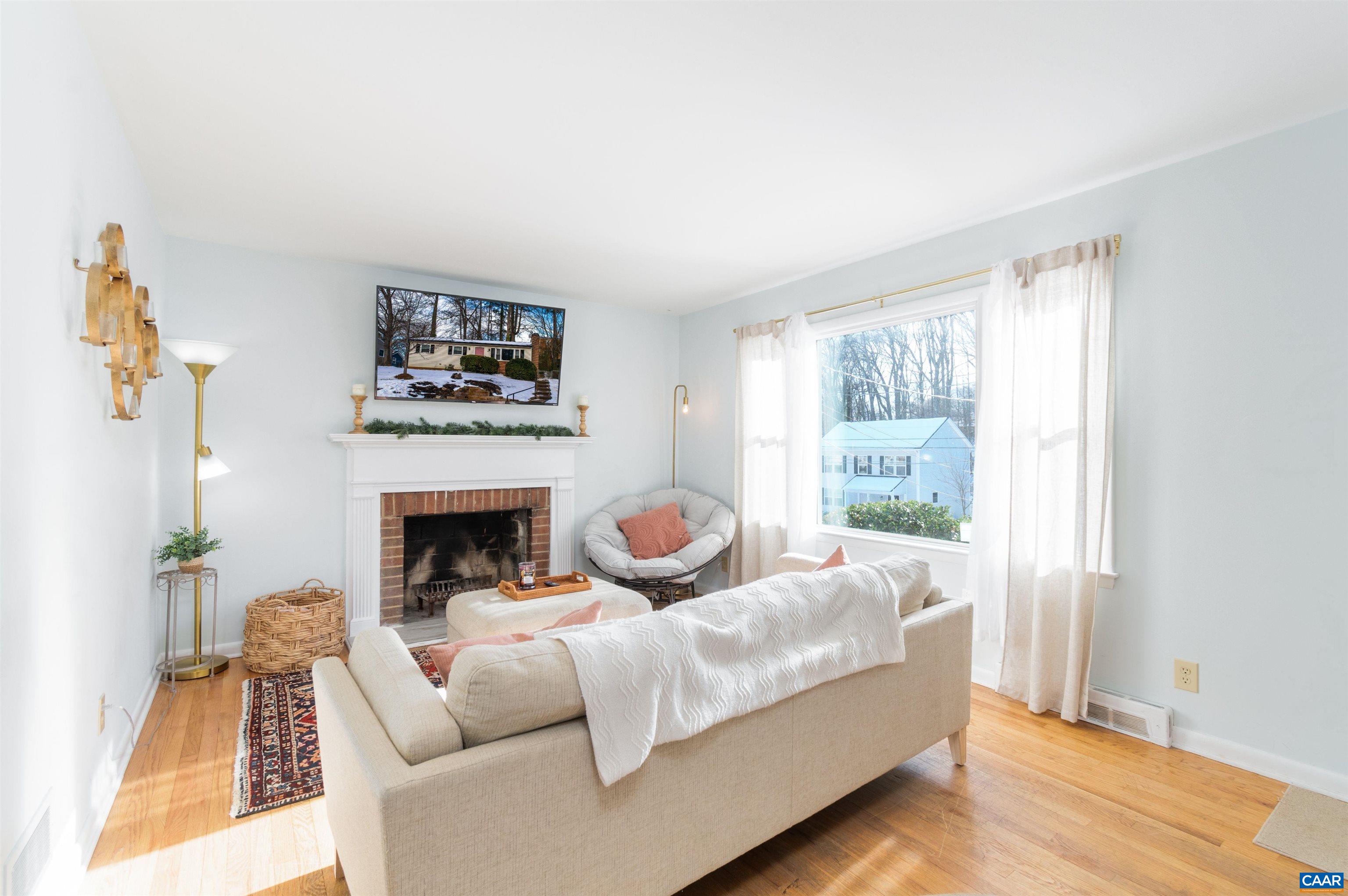 707 Rockcreek Road Charlottesville, VA 22903 - Photo 5 of 26 a living room with furniture a fireplace and a large window
