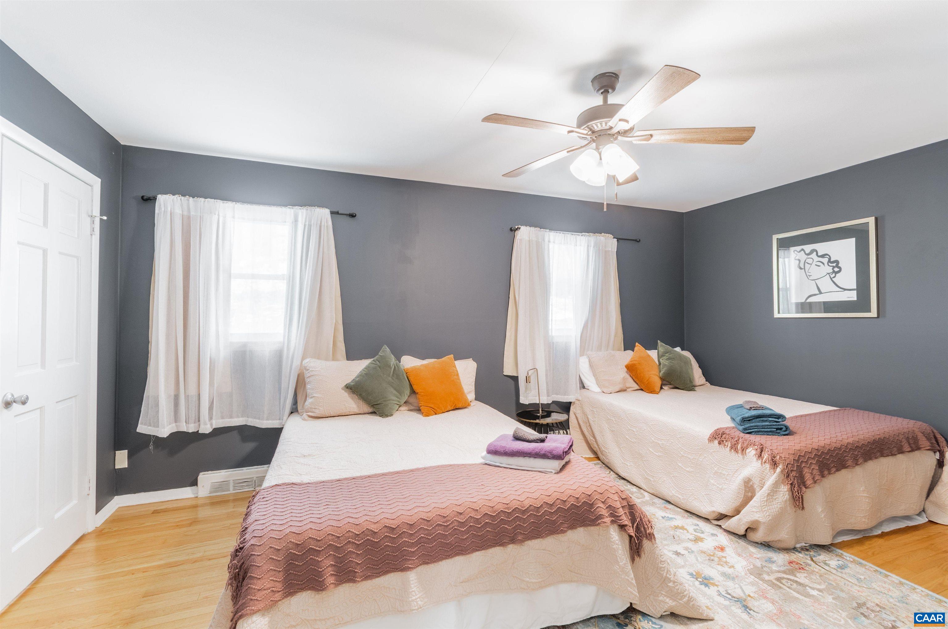 707 Rockcreek Road Charlottesville, VA 22903 - Photo 9 of 26 a bedroom with a bed and a chandelier