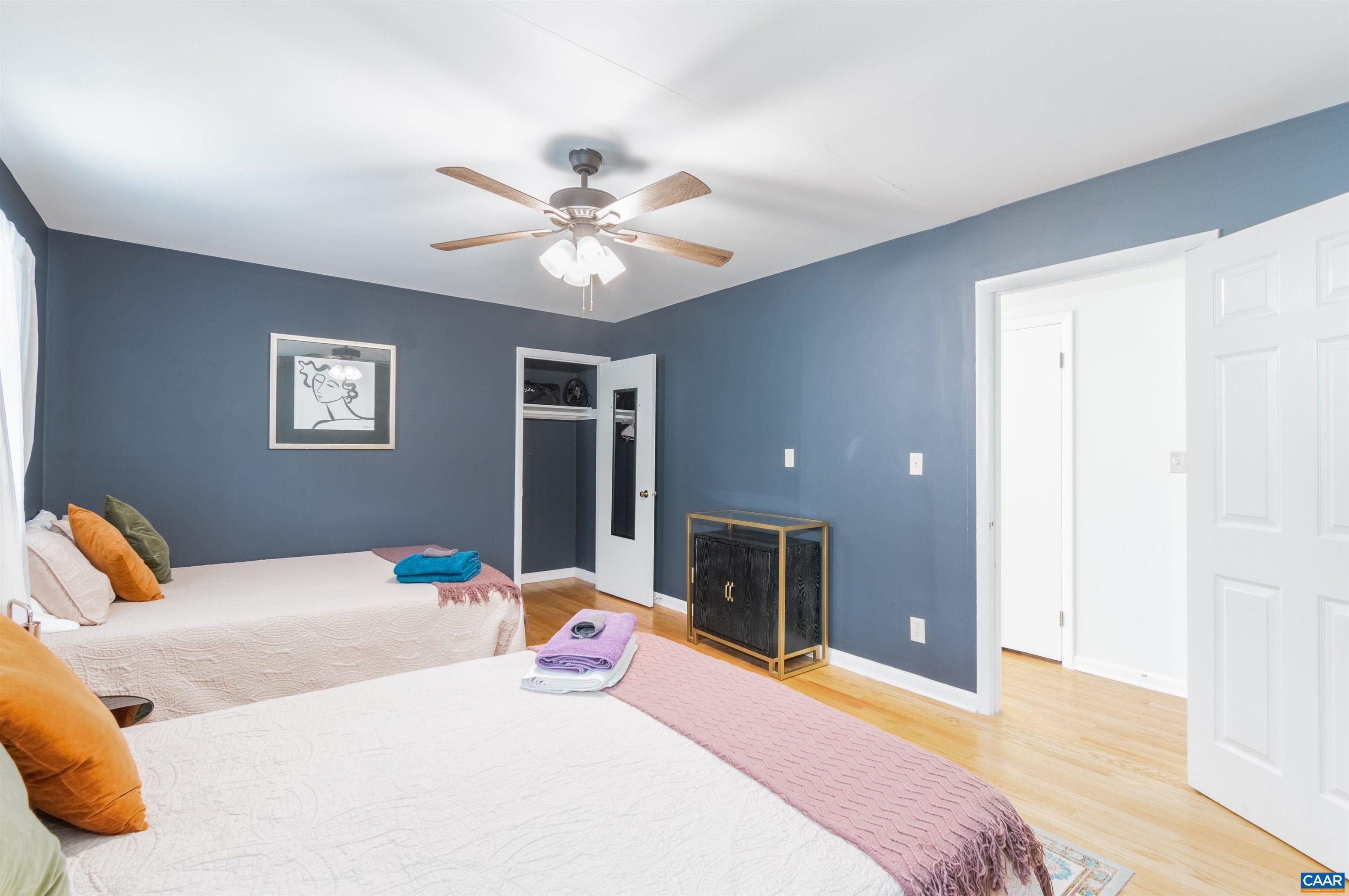 707 Rockcreek Road Charlottesville, VA 22903 - Photo 10 of 26 a bedroom with a bed and a chandelier