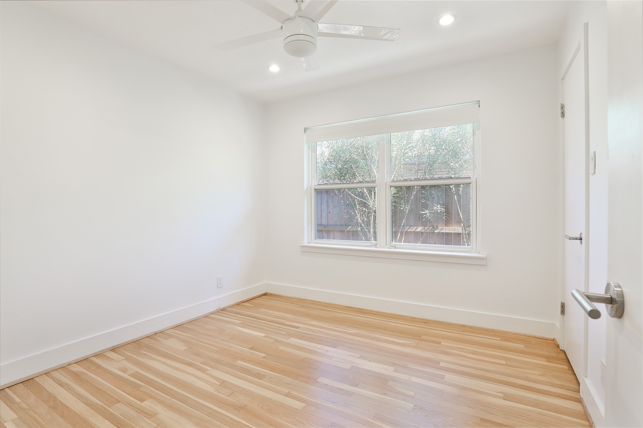 4613 Libbey Drive Houston, TX 77092 - Photo 13 of 26 an empty room with wooden floor and windows