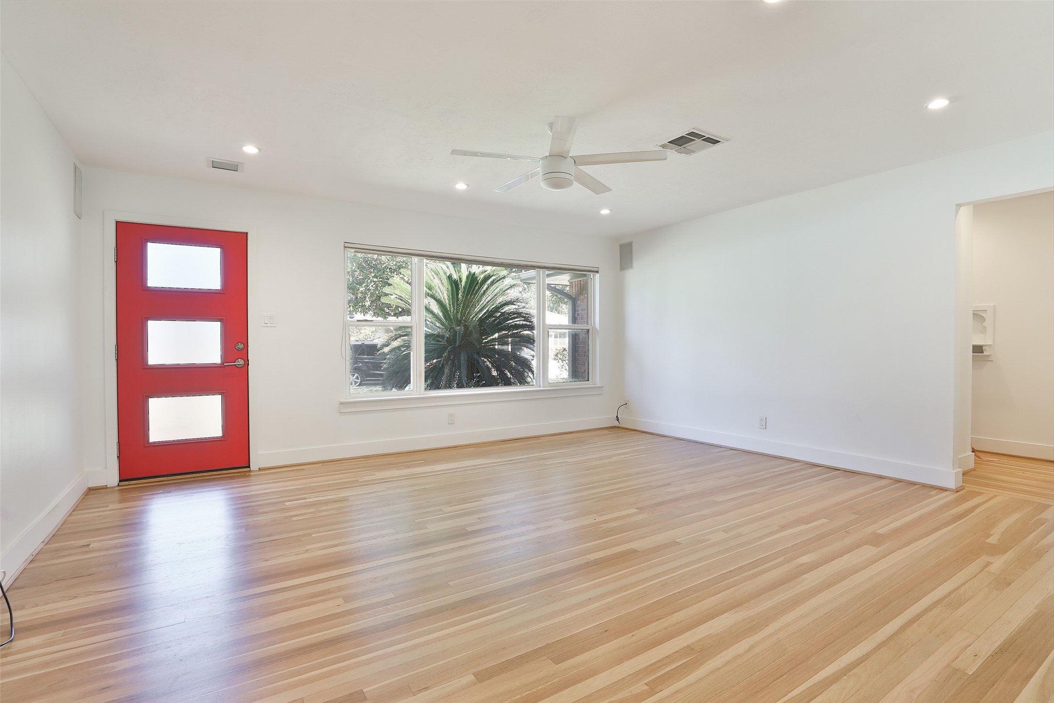 4613 Libbey Drive Houston, TX 77092 - Photo 4 of 26 an empty room with wooden floor and windows