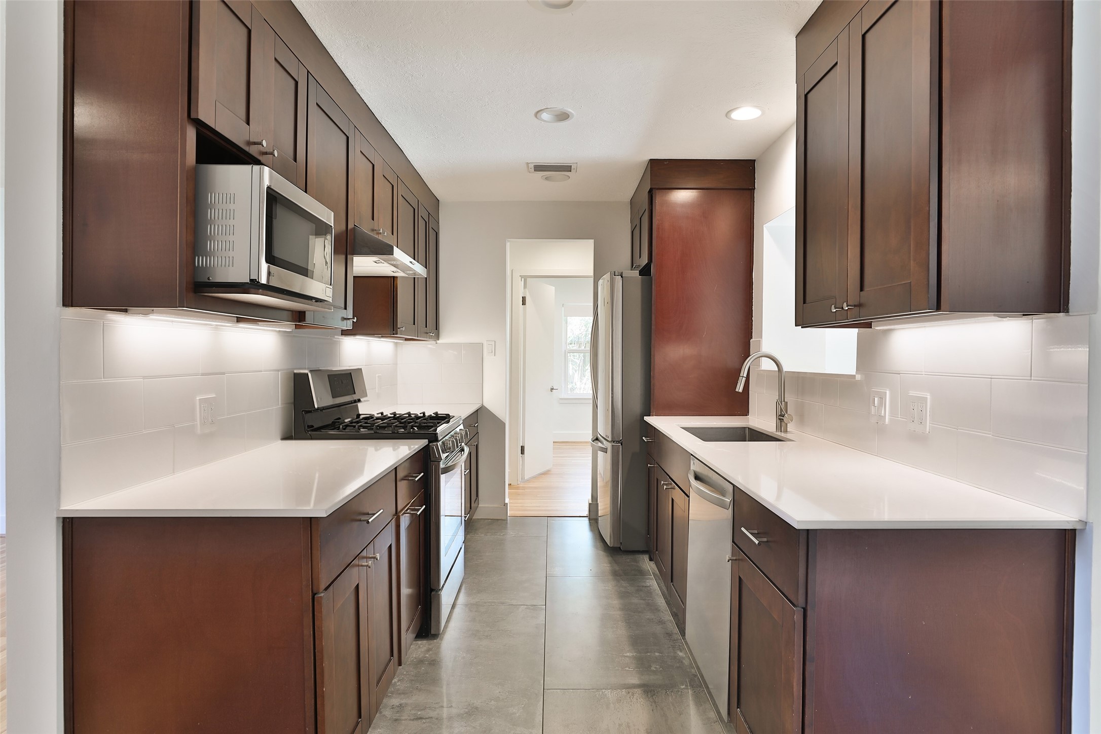 4613 Libbey Drive Houston, TX 77092 - Photo 6 of 26 a kitchen with stainless steel appliances granite countertop a sink stove and refrigerator
