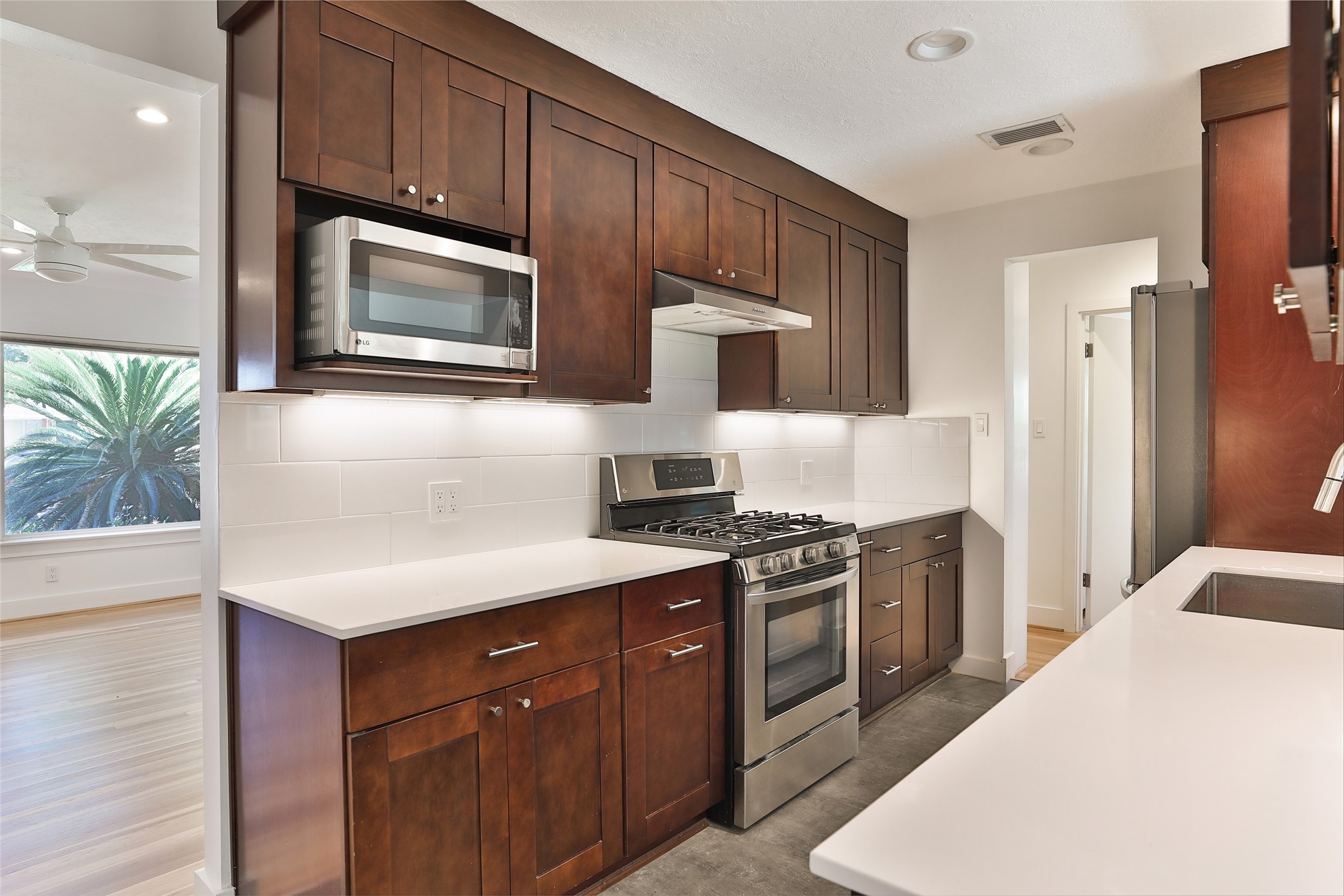 4613 Libbey Drive Houston, TX 77092 - Photo 7 of 26 a kitchen with a sink stove and microwave