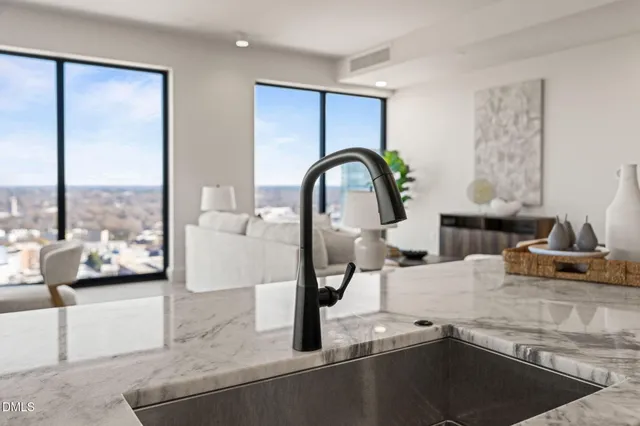 a living room with furniture and a view of kitchen