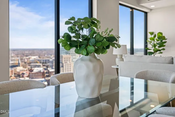 a living room with furniture and flower pot